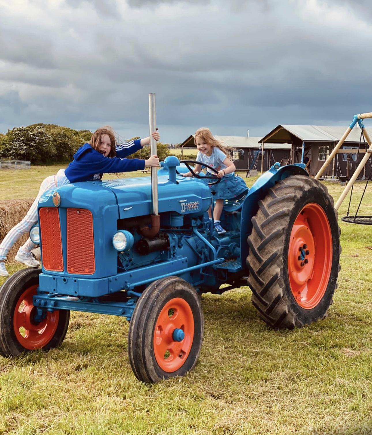 Playing on the tractor at Balnab Dairy Farm