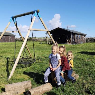 Children playing at Balnab Dairy Farm outside off-grid safari tents